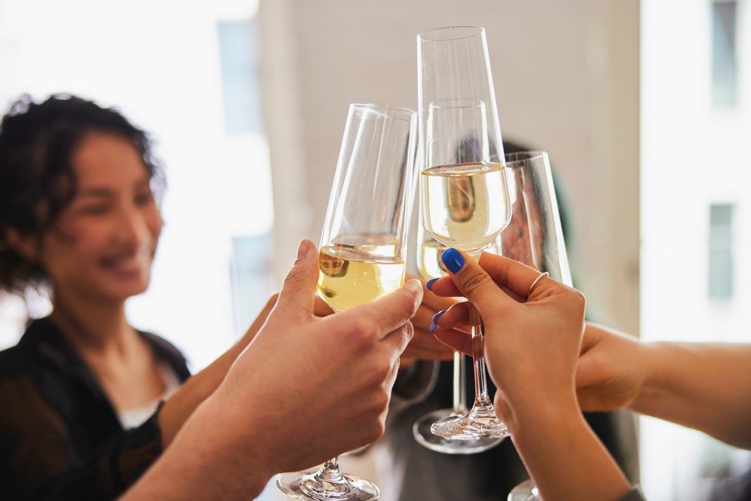 Friends toasting champagne glasses together