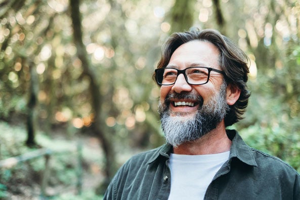Man with beard smiling outdoors